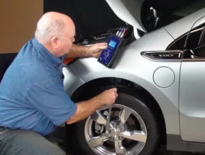 Automotive technician using ALL-TEST PRO 34 EV to diagnose hybrid vehicle motor in Australian workshop